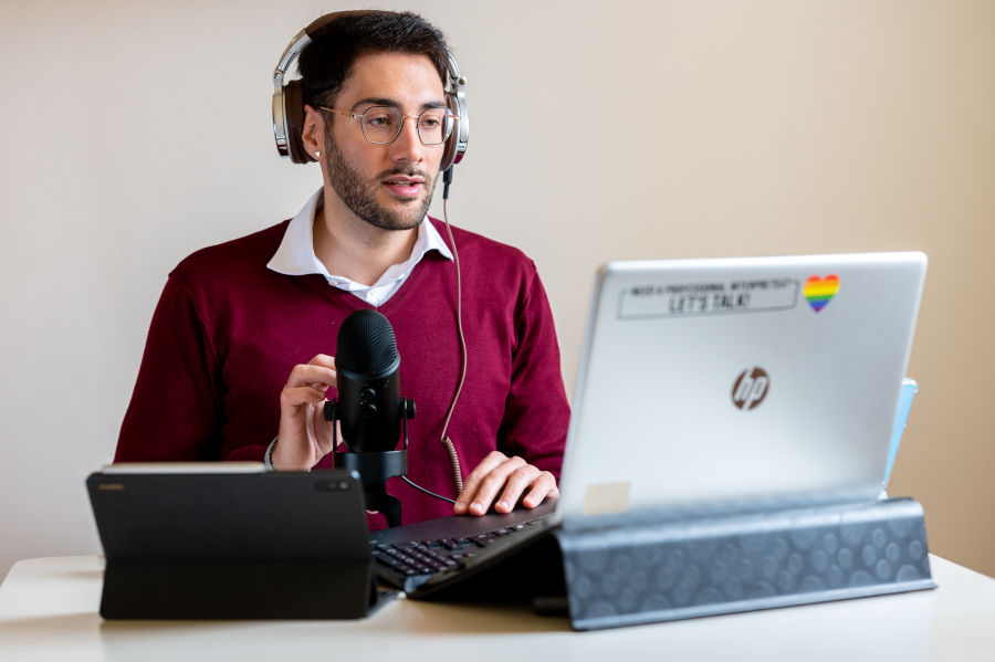 Giacomo Collini, conference interpreter, sitting at his desk and translating simultaneously online